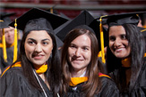 photo of three female students in cap and gown